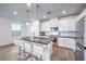 Modern kitchen featuring a large island with seating, stainless steel appliances, and a bright, open design at 11640 Desert Hollow Ave, Las Vegas, NV 89138