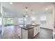 Open-concept kitchen with a center island, stainless steel dishwasher, and seamless flow to the adjacent living area at 11640 Desert Hollow Ave, Las Vegas, NV 89138