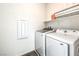 Convenient laundry room with modern washer and dryer and storage shelf at 11640 Desert Hollow Ave, Las Vegas, NV 89138