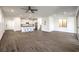 Open-concept living space with wood-look floors and a kitchen featuring a breakfast bar at 11640 Desert Hollow Ave, Las Vegas, NV 89138