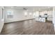 Bright, open-concept living space combining kitchen and living areas with modern flooring and abundant natural light at 11640 Desert Hollow Ave, Las Vegas, NV 89138