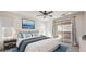 Virtually staged bedroom with a ceiling fan and access to a private balcony at 11640 Desert Hollow Ave, Las Vegas, NV 89138