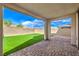 Home patio with pavers and artificial turf on a clear day at 11640 Desert Hollow Ave, Las Vegas, NV 89138