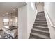 Staircase featuring carpeted steps, modern railing, and natural light at 11640 Desert Hollow Ave, Las Vegas, NV 89138