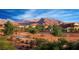Scenic street view with mature trees and walking paths in a beautiful community with a mountain backdrop at 11640 Desert Hollow Ave, Las Vegas, NV 89138