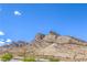 Clear view of a mountain range against a cloudless blue sky and sparse desert landscape at 11640 Desert Hollow Ave, Las Vegas, NV 89138