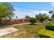 Spacious backyard with lawn, trees, and block fencing at 1643 E St, Las Vegas, NV 89106
