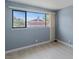 Bedroom featuring neutral walls, wood-look floors, and large window view at 1643 E St, Las Vegas, NV 89106