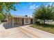 Exterior shot of home with a covered carport and mature landscaping at 1643 E St, Las Vegas, NV 89106