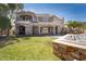 Lush backyard with a hot tub, manicured lawn, and fountain, perfect for entertaining at 1800 Melfi Ct, Henderson, NV 89012