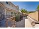 Backyard featuring a landscaped brick patio, privacy wall, and multiple stories of home at 1800 Melfi Ct, Henderson, NV 89012