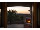 Picturesque balcony with a stone fireplace offers stunning sunset views and a perfect outdoor living space at 1800 Melfi Ct, Henderson, NV 89012