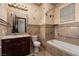 Bathroom with soaking tub, tiled walls, and vanity at 1800 Melfi Ct, Henderson, NV 89012