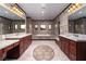 Elegant bathroom featuring dual vanities, jacuzzi tub, and intricate tile design at 1800 Melfi Ct, Henderson, NV 89012