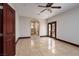 Spacious bedroom with beautiful tile floors, ensuite bathroom, and private patio access at 1800 Melfi Ct, Henderson, NV 89012