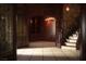 Dark wood paneled foyer with stone wall and staircase at 1800 Melfi Ct, Henderson, NV 89012