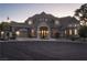Stately home featuring a circular driveway, porte-cochere, and meticulous landscaping for grand curb appeal at 1800 Melfi Ct, Henderson, NV 89012