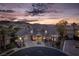 Stunning luxury home featuring stone accents, elegant architecture, and a porte cochere, set against a scenic mountain backdrop at 1800 Melfi Ct, Henderson, NV 89012
