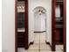 Hallway view featuring tile flooring, arched doorway, bathroom, and closet at 1800 Melfi Ct, Henderson, NV 89012