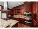 Gourmet kitchen featuring custom cabinets, granite countertops, and high-end stainless steel appliances at 1800 Melfi Ct, Henderson, NV 89012