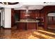 Spacious kitchen featuring custom wood cabinetry, a kitchen island, and modern stainless steel appliances at 1800 Melfi Ct, Henderson, NV 89012