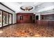 Spacious living room features custom wood flooring, a ceiling fan, and custom built-in cabinets at 1800 Melfi Ct, Henderson, NV 89012