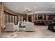 Spacious living room featuring stone walls, a bar area, and natural light at 1800 Melfi Ct, Henderson, NV 89012