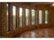 Bright living room featuring stone walls, wood flooring, and a wall of windows at 1800 Melfi Ct, Henderson, NV 89012
