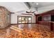 Spacious living room with access to the patio, custom floors, and stone walls at 1800 Melfi Ct, Henderson, NV 89012