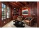 Cozy office with wood-paneled walls, comfortable seating, and a large window with natural light at 1800 Melfi Ct, Henderson, NV 89012