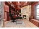 Well-appointed office with built-in bookshelves, a stone fireplace, and a comfortable workspace at 1800 Melfi Ct, Henderson, NV 89012