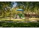 Community playground featuring a climbing structure, slide, swing set, and shaded seating area for residents to enjoy at 1800 Melfi Ct, Henderson, NV 89012