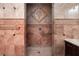 Shower with marble tile, unique tiling design, and grab bars at 1800 Melfi Ct, Henderson, NV 89012