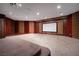 Large theater room with tiered seating and a big screen at 1800 Melfi Ct, Henderson, NV 89012