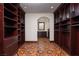 Spacious walk-in closet with custom shelving and hardwood floors at 1800 Melfi Ct, Henderson, NV 89012