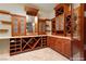 Custom wine cellar with wooden shelves, cabinets, and counter space at 1800 Melfi Ct, Henderson, NV 89012