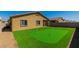 Large synthetic grass backyard with a putting green and a privacy wall at 4333 Glossier Ave, North Las Vegas, NV 89084