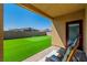 Covered patio with synthetic grass backyard, a putting green, and a privacy wall at 4333 Glossier Ave, North Las Vegas, NV 89084