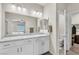Bathroom with double sinks, granite countertop, walk-in closet, and separate toilet area at 4333 Glossier Ave, North Las Vegas, NV 89084