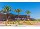 Entrance to Valley Vista featuring palm trees and colorful desert landscaping at 4333 Glossier Ave, North Las Vegas, NV 89084
