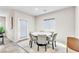 Cozy dining room featuring a round table, modern chairs, and natural light at 4333 Glossier Ave, North Las Vegas, NV 89084