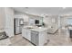 Open-concept kitchen with granite island, stainless steel appliances, and seamless flow into the living area at 4333 Glossier Ave, North Las Vegas, NV 89084