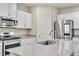 Bright kitchen features granite countertops, modern appliances, and white cabinetry at 4333 Glossier Ave, North Las Vegas, NV 89084
