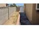 Long, narrow backyard with block wall fencing and a sidewalk that creates a clean and secure outdoor space at 5157 New Bedford Dr, Las Vegas, NV 89122