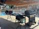 Covered patio with grill and outdoor cooking space near a pool at 5157 New Bedford Dr, Las Vegas, NV 89122
