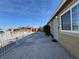 Wide backyard includes metal gates and access to the home's back entrance at 5157 New Bedford Dr, Las Vegas, NV 89122