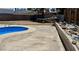 Spacious backyard with pool, large concrete patio, rock feature, and ample space for activities at 5157 New Bedford Dr, Las Vegas, NV 89122