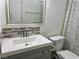 Bathroom includes updated vanity, sink, and modern decorative mirror at 5157 New Bedford Dr, Las Vegas, NV 89122