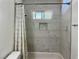 Updated bathroom features white marble tile in the bathtub and shower surround at 5157 New Bedford Dr, Las Vegas, NV 89122