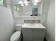 Charming bathroom with a sleek vanity, toilet, and decorative mirror at 5157 New Bedford Dr, Las Vegas, NV 89122
